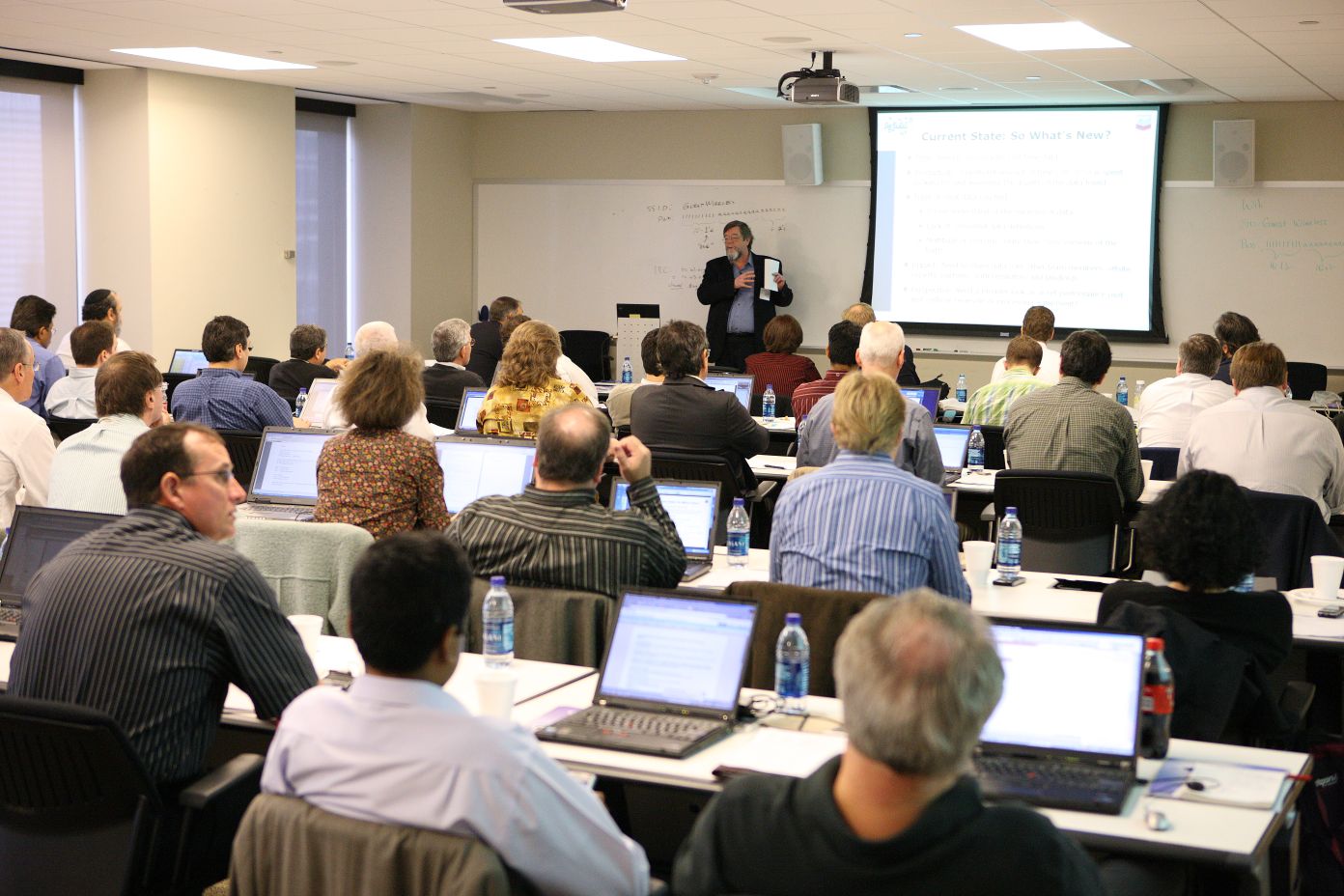 Jim Crompton giving his keynote, with a large audience in the meeting room