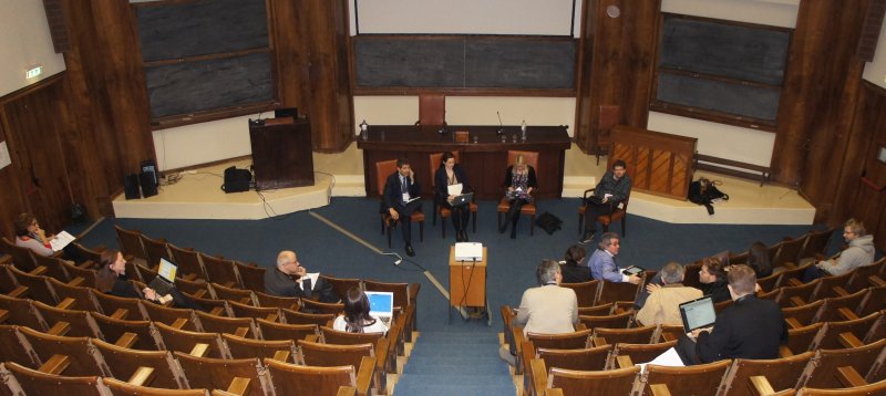 view from the back of the small auditorium - we see a very steep rake of seating with distant figures