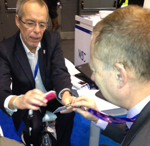 Bernard Gidon scanning a name tag at the booth.